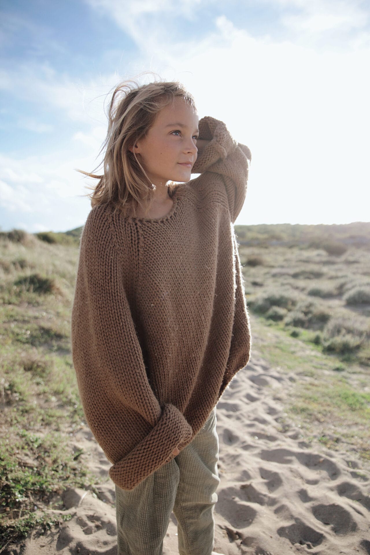 blond model boy long hair summer sunlight beach smile