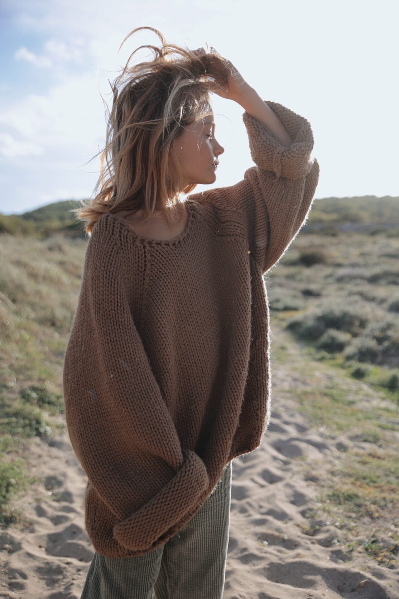 blond model boy long hair summer sunlight beach