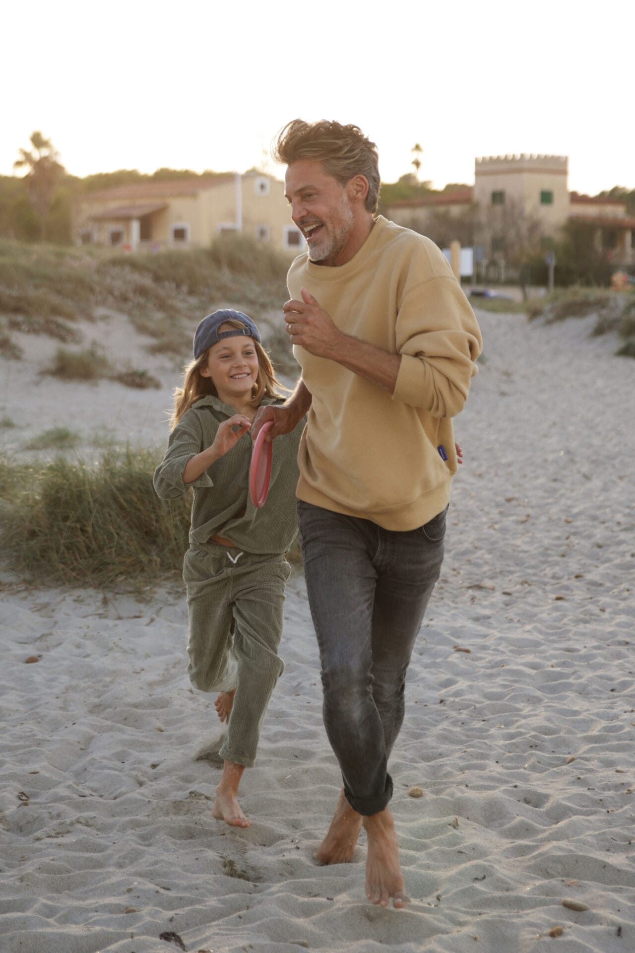 family models father son casing beach frisbee