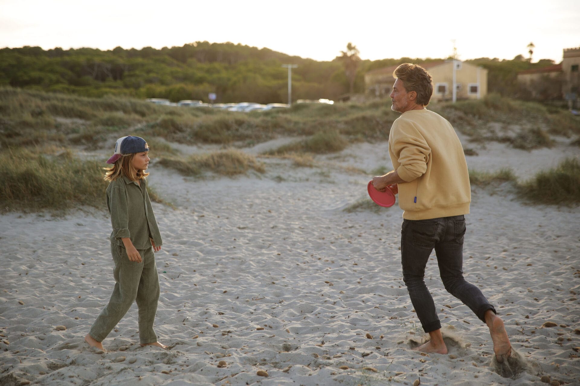 family models father son playing beach