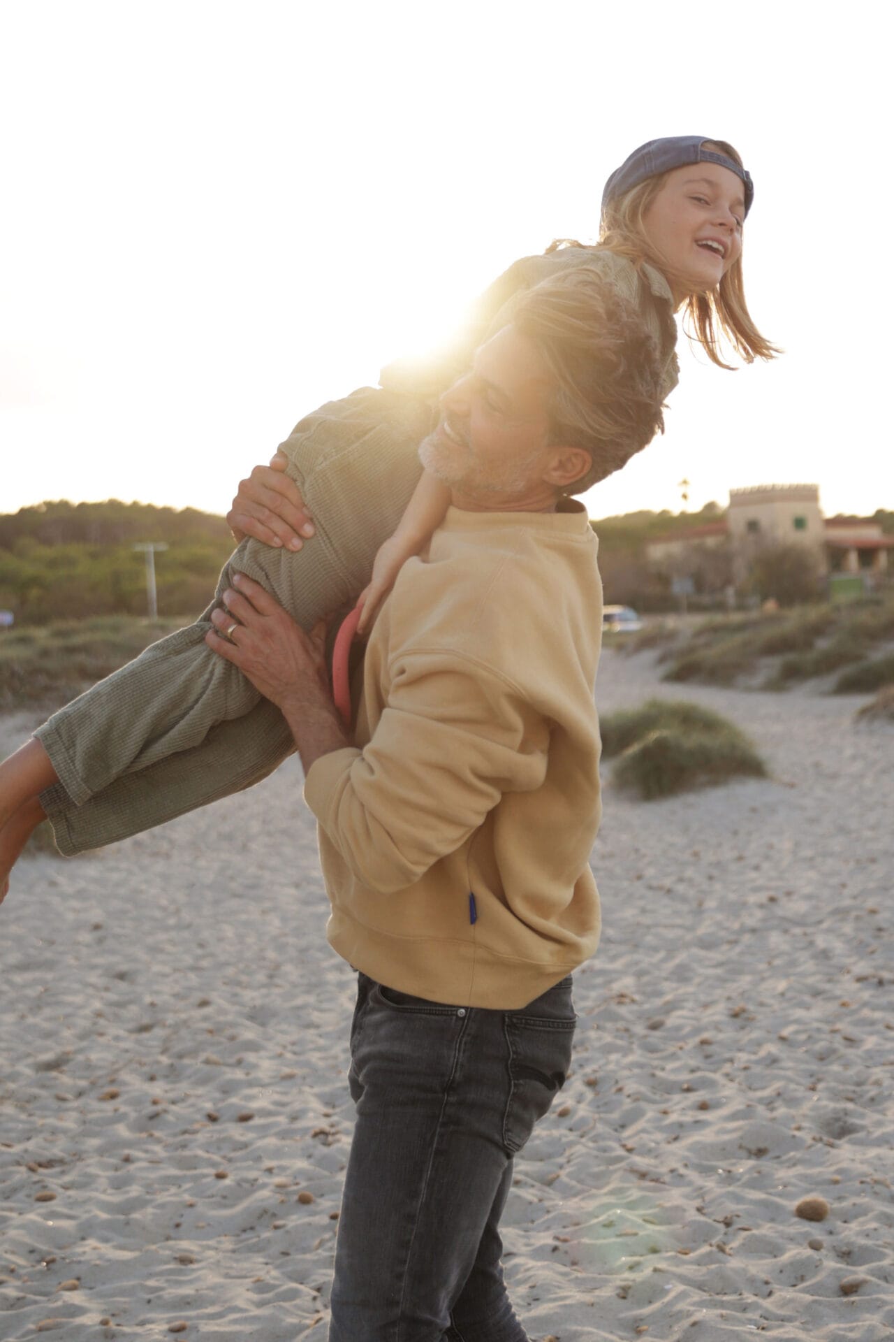 family models father son on shoulders beach