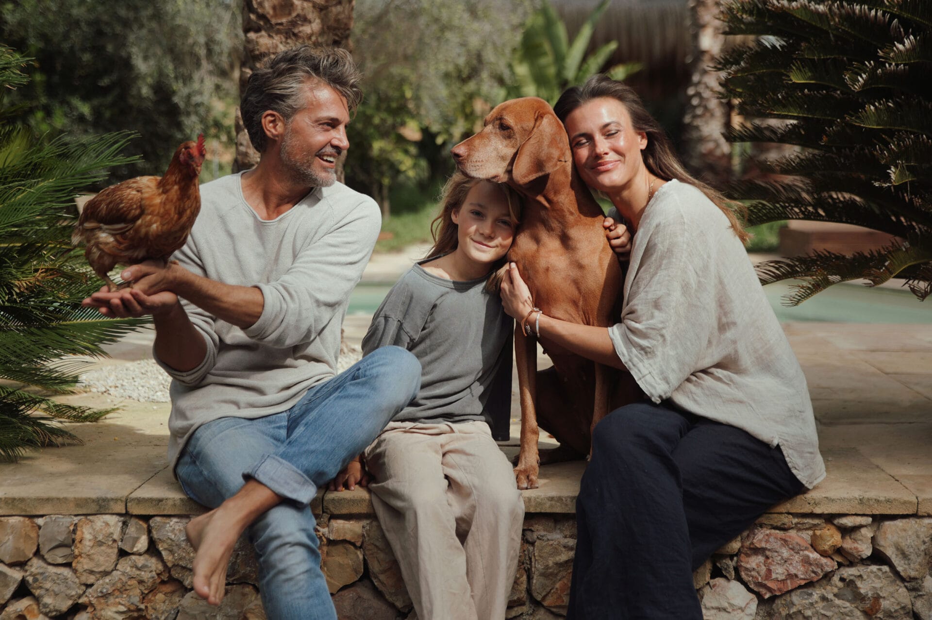 happy model family with dog and chickens