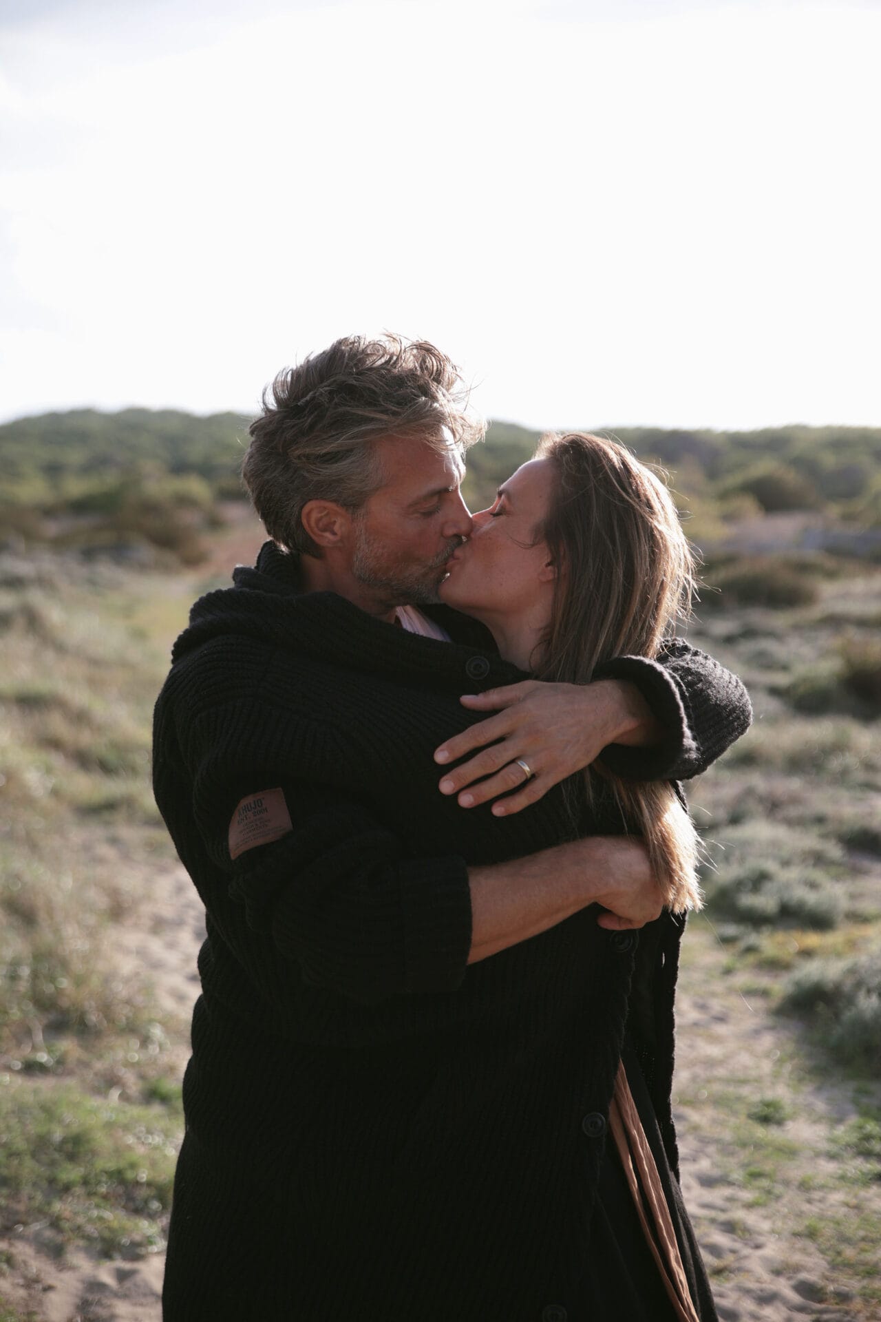 model couple mallorca hugging and kissing at the beach