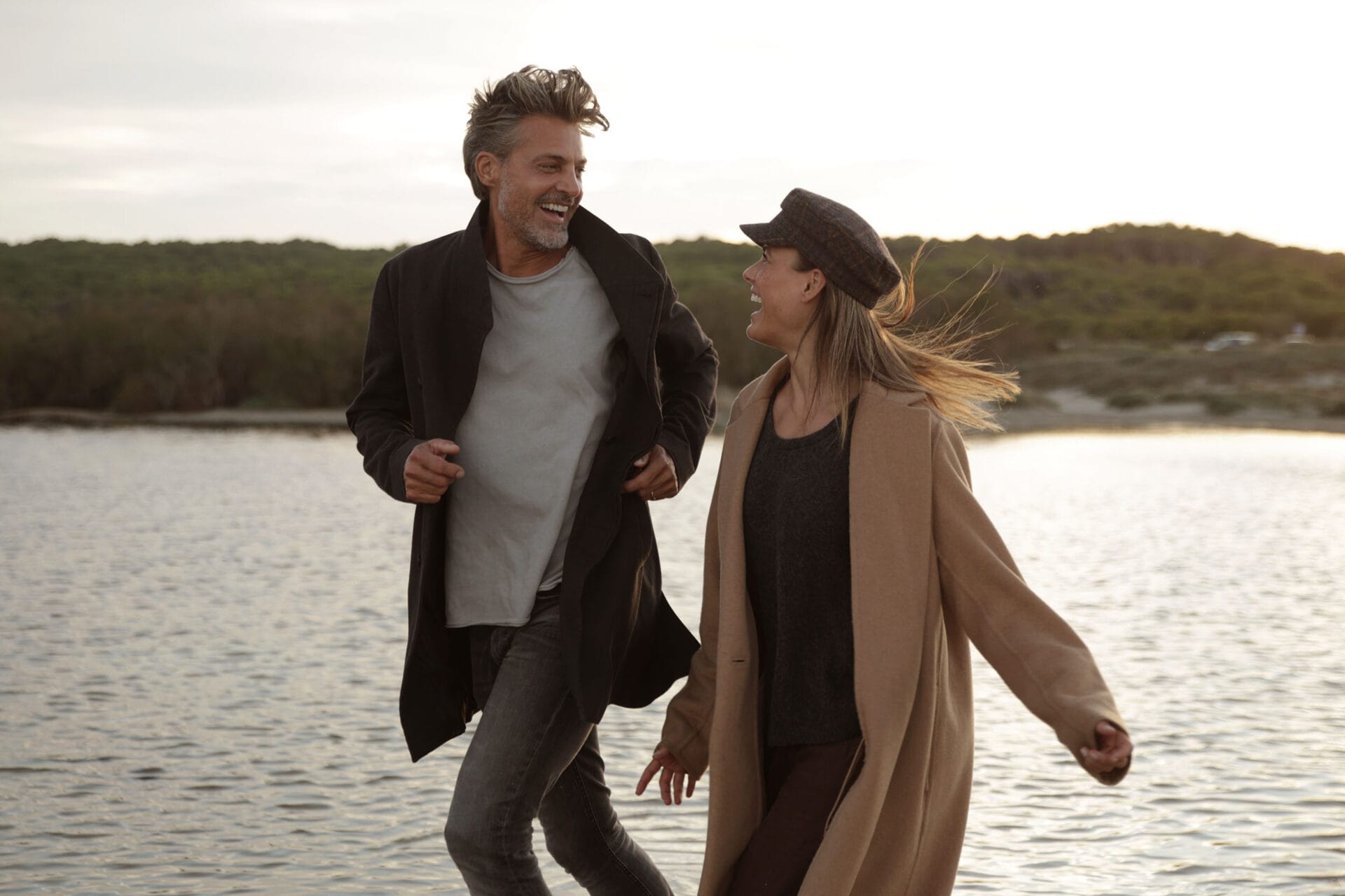 model couple mallorca laughing running at the beach